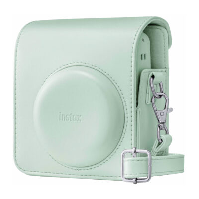 Funda verde pastel para cámara Instax con cierre y correa ajustable, ideal para fotografía instantánea.