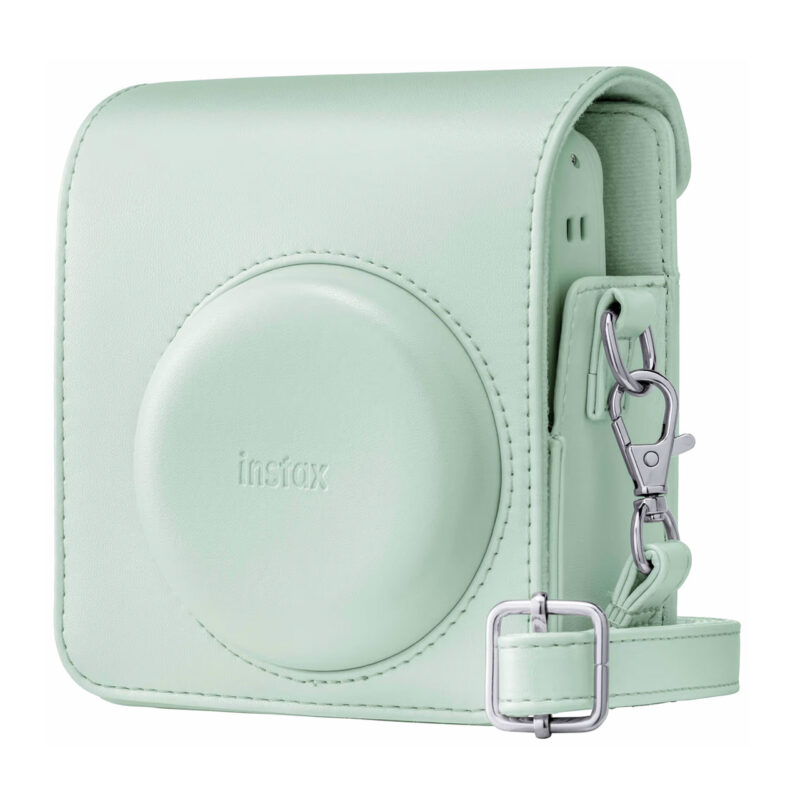 Funda verde pastel para cámara Instax con cierre y correa ajustable, ideal para fotografía instantánea.
