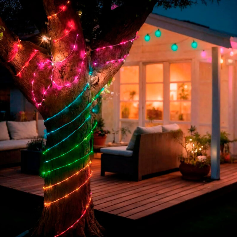 HAM600003-8-1BF Decorative LED light on a tree, with pink, green and blue colors, illuminating a cozy outdoor environment.