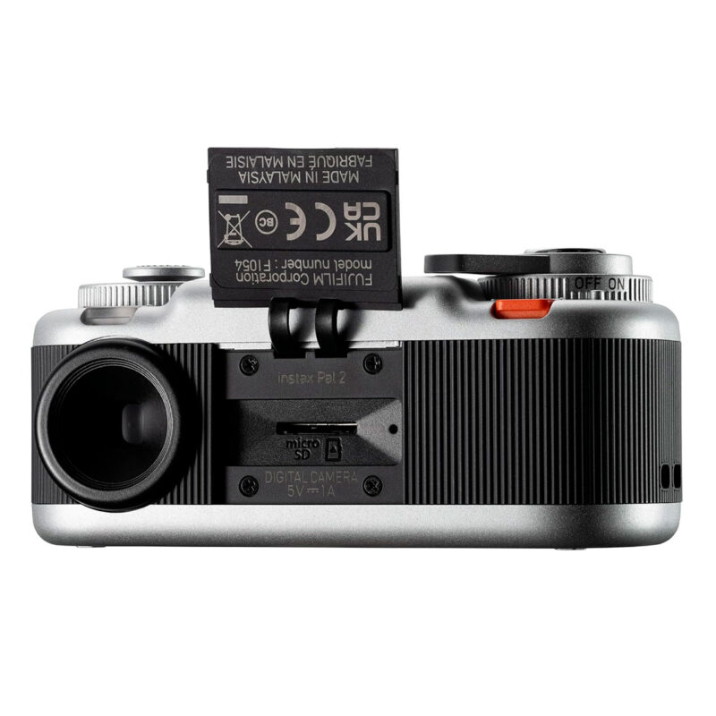 fuj170518-6-67a Cámara Fujifilm Instax Pal 2 con lente y tarjeta micro SD visible, diseño compacto y moderno, ideal para fotos instantáneas.